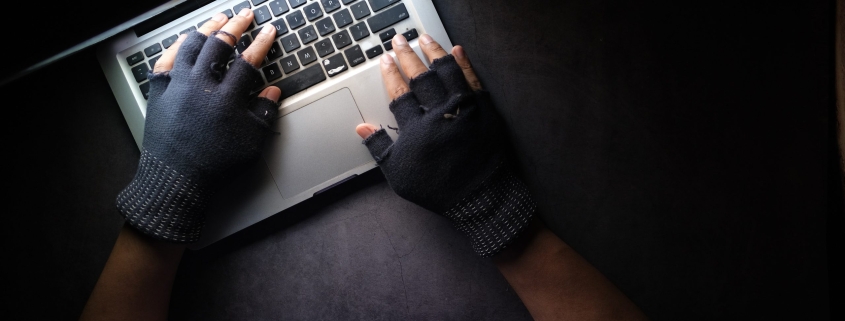 person in black long sleeve shirt using macbook pro