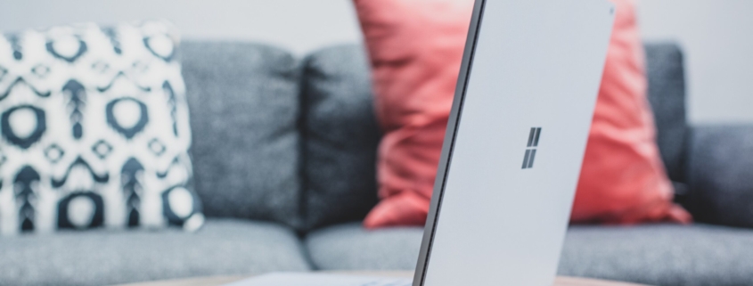 macbook pro on white couch