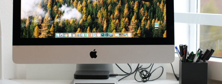 Free Turned on Silver Imac With Might Mouse and Keyboard Stock Photo